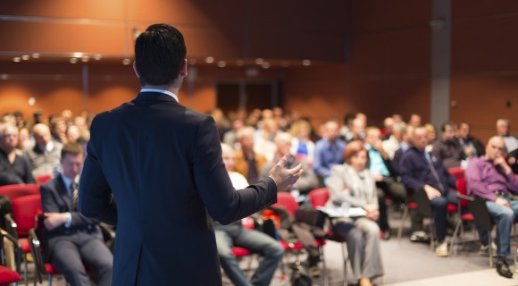 Seminar speaker in front of an audience.