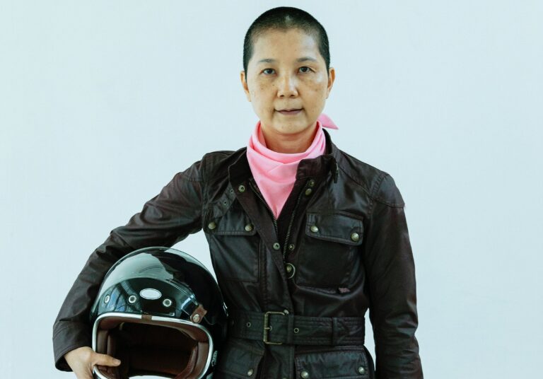 Person holding a motorcycle helmet.