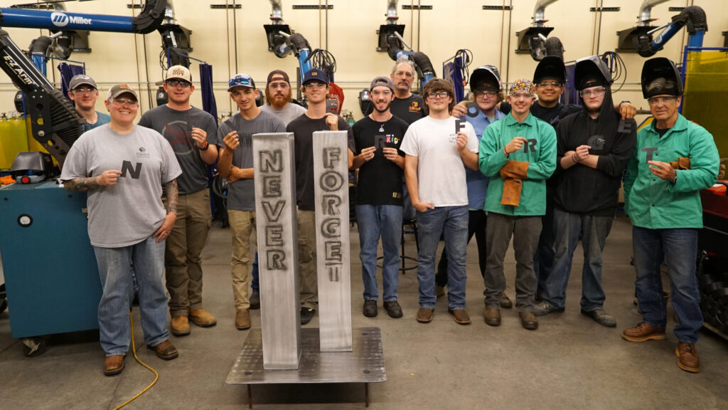 Mitchell Welding Technology students with a model of the Twin Towers in remembrance of 9/11.