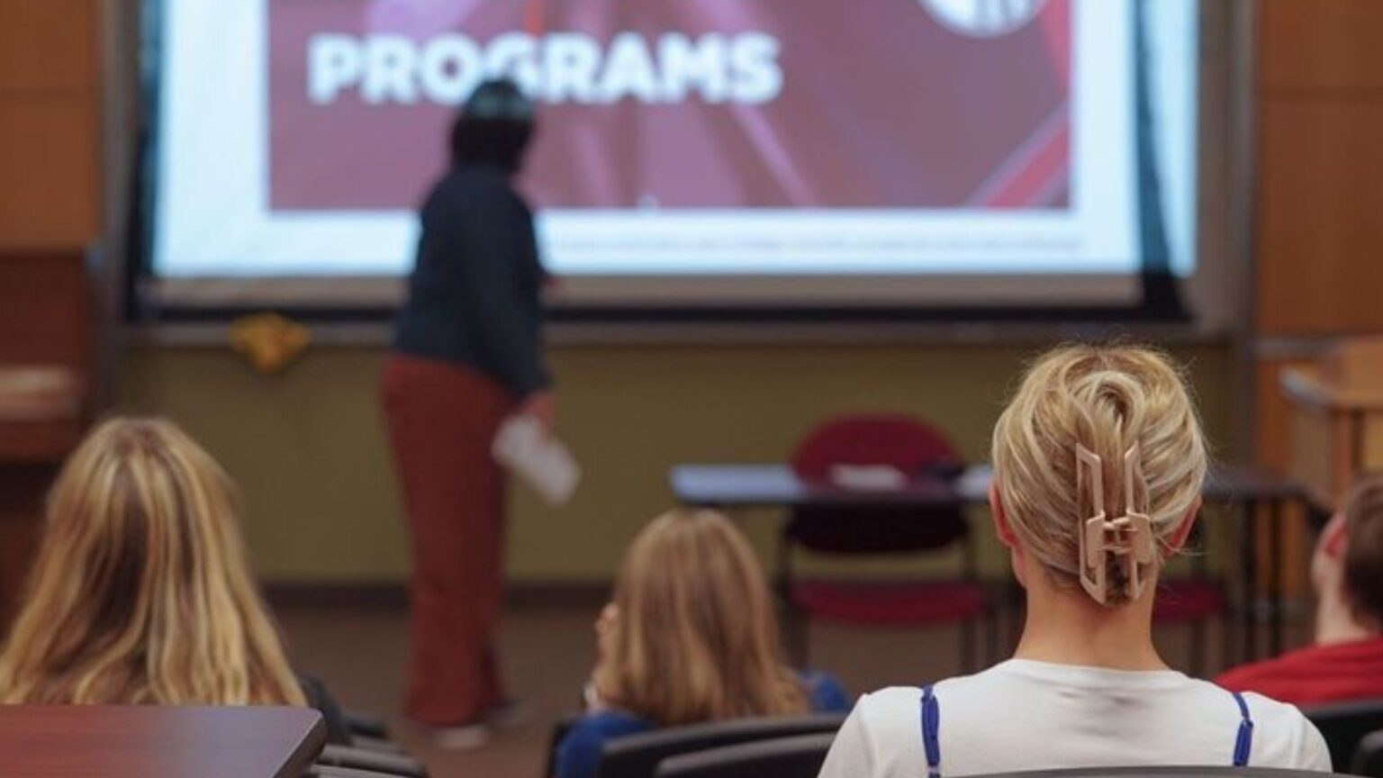 A Mitchell student watching a presentation.
