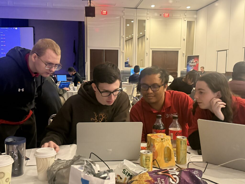 This is a photo of students competing at the 2026 Minutemen Cyber Cup Competition.