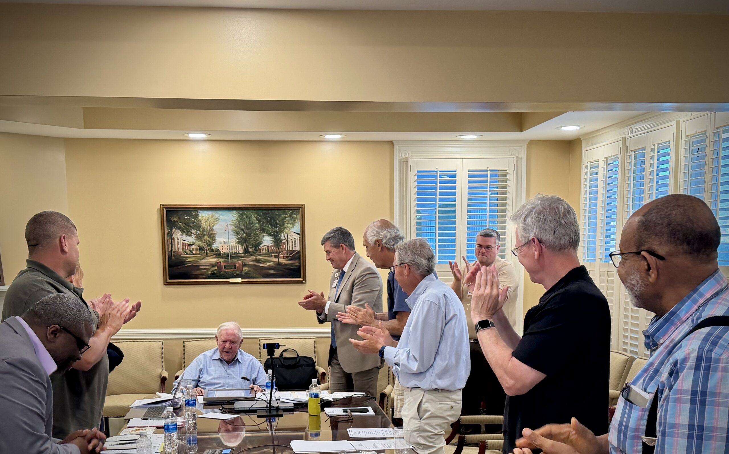The Mitchell Board of Trustees stands for Dr. Ralph Bentley as he retires after 30 years